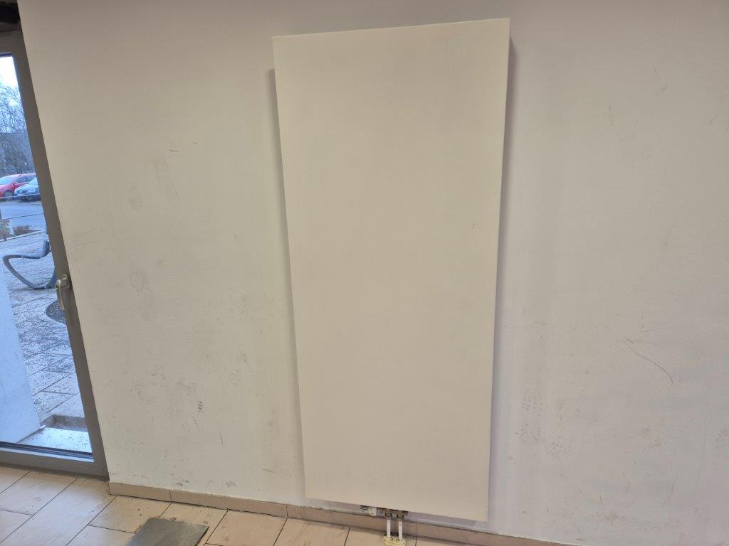 Das Bild zeigt einen weißen Heizkörper, der von rotem Graffiti befreit wurde, nach der Graffiti-Entfernung durch WarDaWas.